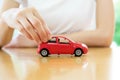 A Business woman by a desk holding a toy car. Royalty Free Stock Photo