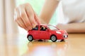 A Business woman by a desk holding a toy car. Royalty Free Stock Photo