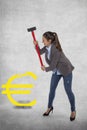 Business woman destroying the euro symbol