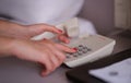 Business woman dialing phone number in hotel room Royalty Free Stock Photo