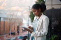 Business woman on a digital tablet outside a modern office alone. Smiling corporate worker looking at web and social Royalty Free Stock Photo