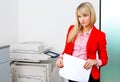 Business woman with documents standing next to printer Royalty Free Stock Photo