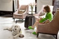 Business woman with dog in lobby of hotel Royalty Free Stock Photo