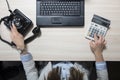 Business woman doing calculations and dialing a phone number Royalty Free Stock Photo