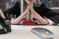 Business woman doing insurance on vehicle, holding red toy car on desk at office Royalty Free Stock Photo