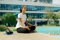 Business Woman Doing Yoga Lotus Position Outside Office Building