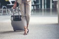 Business woman Dragging suitcase luggage bag,walk to passenger boarding in Airport.Working woman travel to work,wear suit pull Royalty Free Stock Photo
