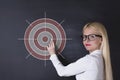 Business woman draw target on the blackboard