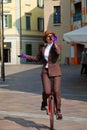 Business woman drink a coffee on the unicycle