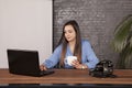 Business woman drinking coffee, copy space behind her back