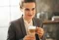 Business woman drinking coffee in loft apartment Royalty Free Stock Photo