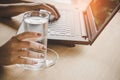 Business woman drinking fresh water while working on computer Royalty Free Stock Photo