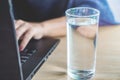 Business woman drinking fresh water while working on computer lapto Royalty Free Stock Photo