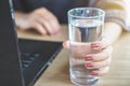 Business woman drinking fresh water while working on computer lapto Royalty Free Stock Photo