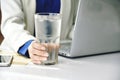 Business woman drinking fresh water while working at the office, A glass of drinking water on office desk Royalty Free Stock Photo