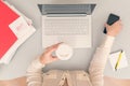 Business woman drinks coffee from paper cups while working on the laptop in an office. Royalty Free Stock Photo