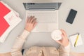 Business woman drinks coffee from paper cups while working on the laptop in an office. Royalty Free Stock Photo