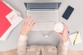 Business woman drinks coffee from paper cups while working on the laptop in an office. Royalty Free Stock Photo