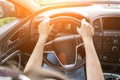 Business woman driving car. Travel car trip on road at sunset. Happy young man have fun ride inside vehicle in summer sunny day Royalty Free Stock Photo