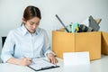 Business woman employee writing and signing on resignation letter before sending to executive