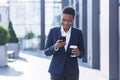 Business woman enjoys cellphone fun and smiling, African American boss businesswoman outside office in business suit Royalty Free Stock Photo