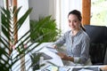 Business woman entrepreneur sitting in bright office and working in internet with laptop computer. Royalty Free Stock Photo