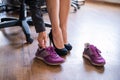 A business woman exchanges high heels for comfortable shoes in the workplace. A close-up of female hands takes off her