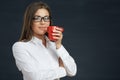 Business woman eyeglasses wearing holding red coffee cup. Royalty Free Stock Photo