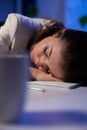 Business woman falling asleep while working at economic statistics