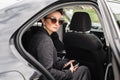 Business woman VIP celebrity public person in luxury car limousine Royalty Free Stock Photo