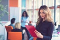 Business woman with folders standing and team mates working in meeting room at office. Royalty Free Stock Photo