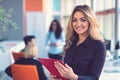 Business woman with folders standing and team mates working in meeting room at office. Royalty Free Stock Photo