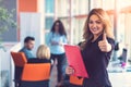 Business woman with folders standing and team mates working in meeting room at office. Royalty Free Stock Photo