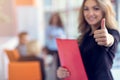 Business woman with folders standing and team mates working in meeting room at office. Royalty Free Stock Photo