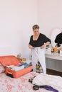 business woman folding clothes to prepare her luggage. tourist woman preparing her suitcase for business trip. Royalty Free Stock Photo