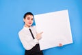 Business woman in formal wear with white panel on blue background Royalty Free Stock Photo