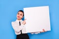 Business woman in formal wear with white panel on blue background Royalty Free Stock Photo