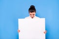 Business woman in formal wear with white panel on blue background Royalty Free Stock Photo