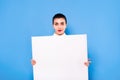 Business woman in formal wear with white panel on blue background Royalty Free Stock Photo