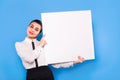 Business woman in formal wear with white panel on blue background Royalty Free Stock Photo