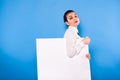 Business woman in formal wear with white panel on blue background Royalty Free Stock Photo