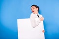 Business woman in formal wear with white panel on blue background Royalty Free Stock Photo