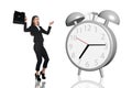 Business woman frightened big gray alarm clock