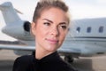 Business woman in front of a corporate jet