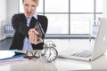 Business woman furious and angry working with computer laptop pointing gun to alarm clock Royalty Free Stock Photo