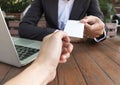 Business woman give business card for customer in coffee shop.