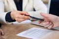 Business woman giving pen to businessman ready to sign contract. Success communication at meeting or negotiation Royalty Free Stock Photo