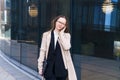 Business woman glasses with laptop her hands talking phone near business center Royalty Free Stock Photo