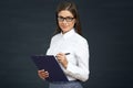 Business woman glasses wearing writing on clipboard. Royalty Free Stock Photo