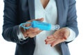 Business woman in grey suit on disinfecting hands